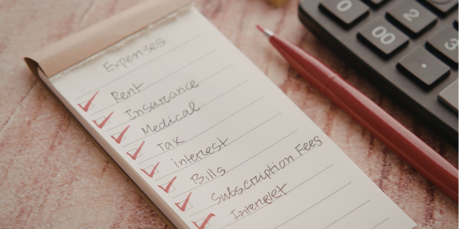 A handwritten expenses checklist with rent, insurance, medical, bills, subscription fees and internet ticked off